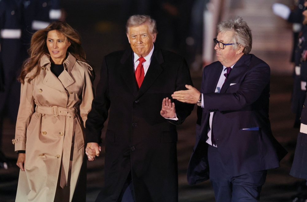 US President Donald Trump and first lady Melania Trump are greeted by Viscount Henry Hood, representing Britain’s King Charles, as they arrive for their state visit to Britain, at London Stansted Airport near London September 16, 2025. — Reuters pic