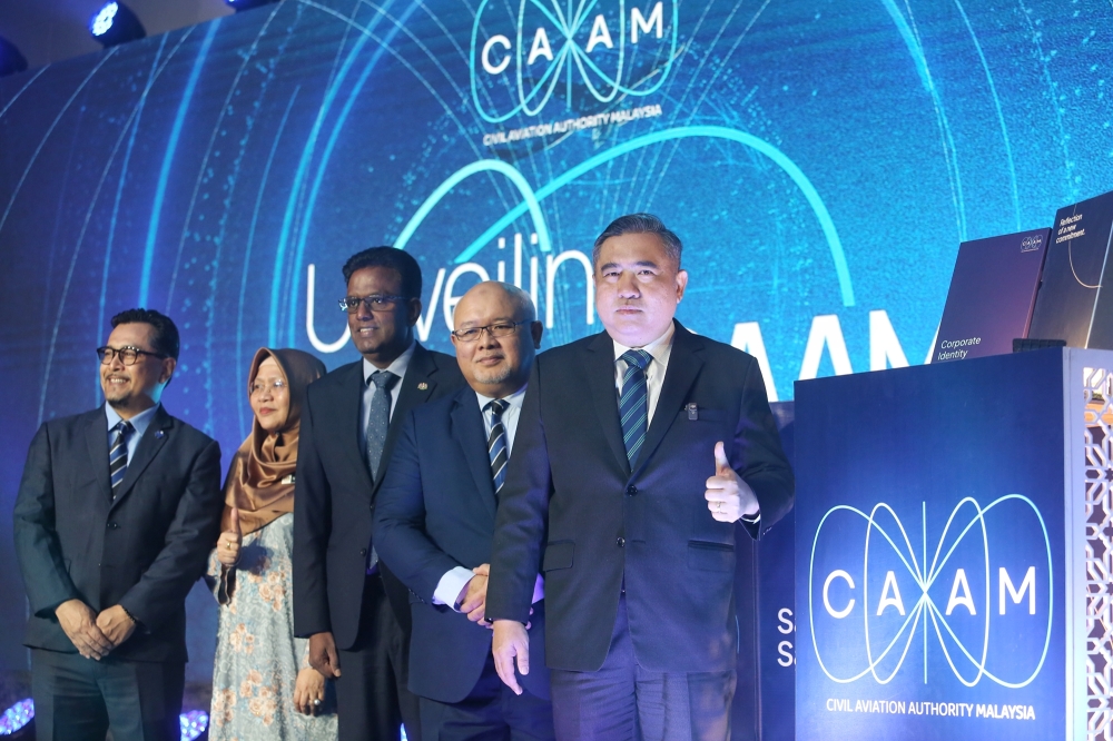 Transport Minister Anthony Loke (right) launches CAAM’s new logo at Le Méridien Putrajaya today. — Picture by Choo Choy May.