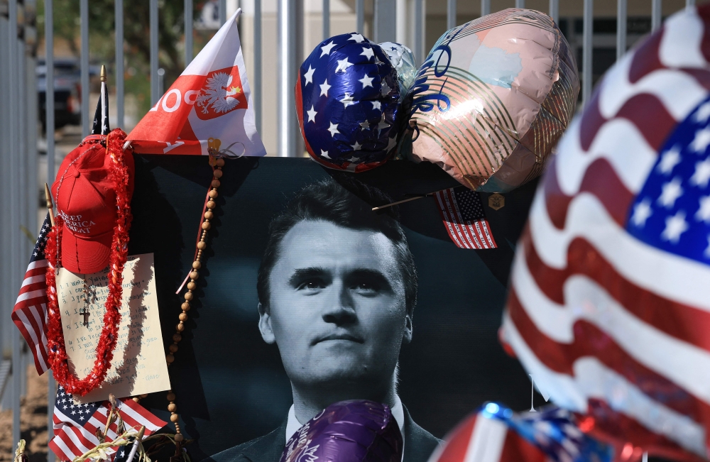 A photograph of Charlie Kirk is placed at a makeshift memorial outside the Turning Point USA headquarters in Phoenix, Arizona, today. The CEO and co-founder of Turning Point USA was shot dead on Sept 10 while speaking at an event at Utah Valley University. — AFP pic
