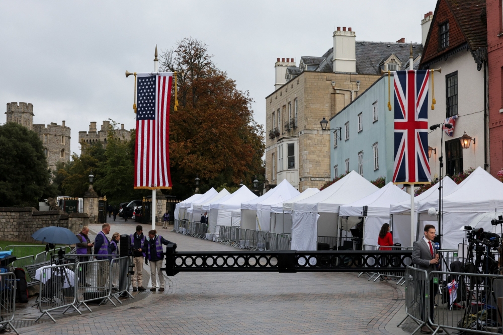 A Union Jack and US flags hang, as media crews setup outside the Windsor Castle, on the day of the state visit of US President Donald Trump and first lady Melania Trump to Britain, in Windsor September 17, 2025. — Reuters pic 