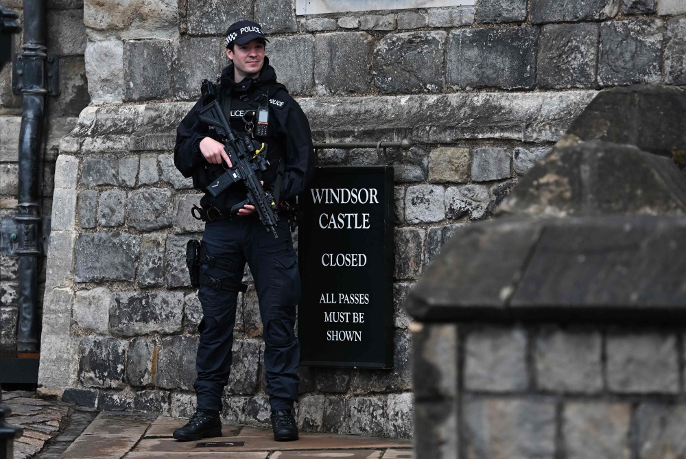 An armed police officer holds their weapon as they stand guard outside Windsor Castle, in Windsor, on September 17, 2025, during US President Donald Trump's second State Visit to the UK. — Reuters pic 