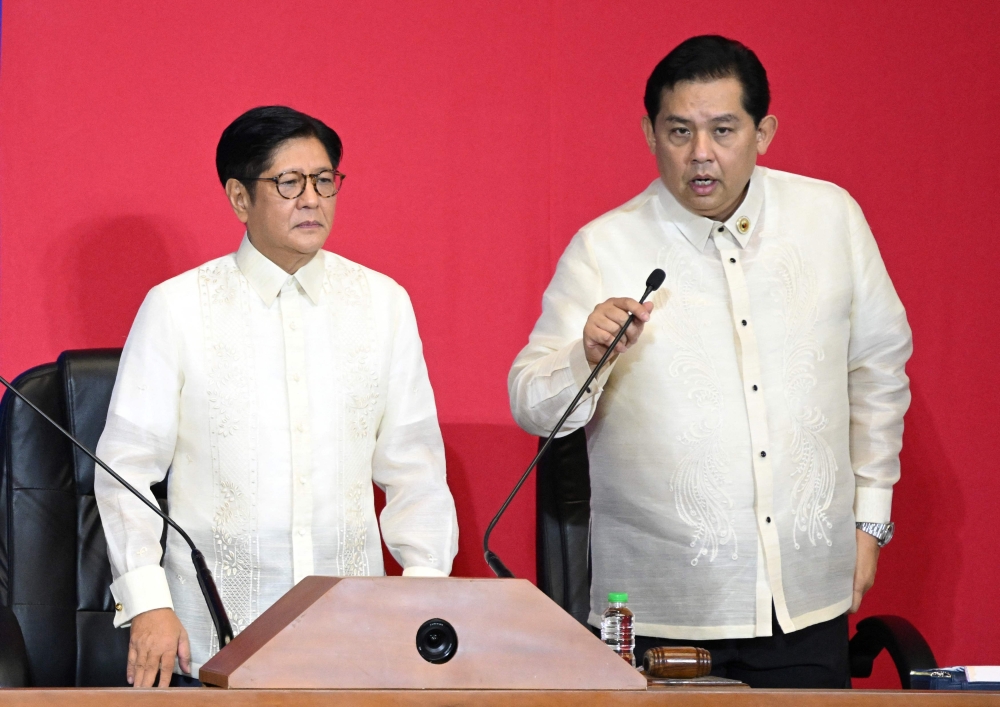 This photo taken on July 28, 2025 shows Philippine President Ferdinand Marcos listening to Speaker of the House Martin Romualdez (right) in the upper rostrum during the State of the Nation Address at the House of Representatives in Manila. The speaker of the Philippine House of Representatives tendered his resignation on September 17, 2025 after his name surfaced in a mounting corruption scandal, less than two weeks after the country’s Senate president suffered the same fate. — AFP pic 