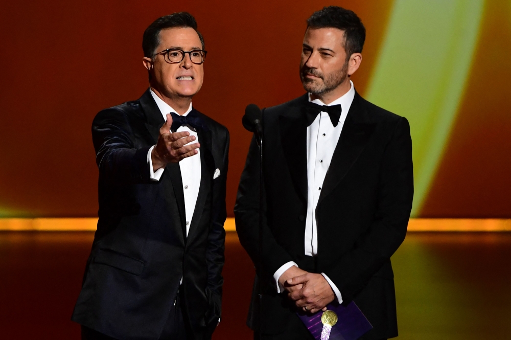 In this file photo taken on September 22, 2019, Stephen Colbert and Jimmy Kimmel speak onstage during the 71st Emmy Awards in Los Angeles. — AFP pic
