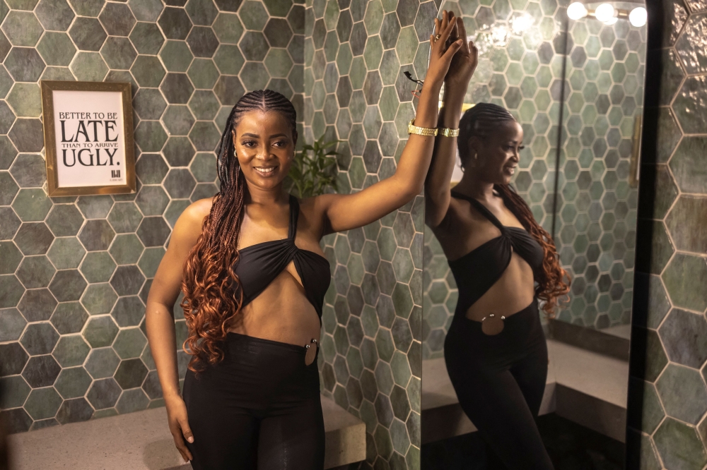 A patron poses for a photograph inside the restroom of The Library restaurant and club in Lagos, on September 7, 2025. — AFP pic