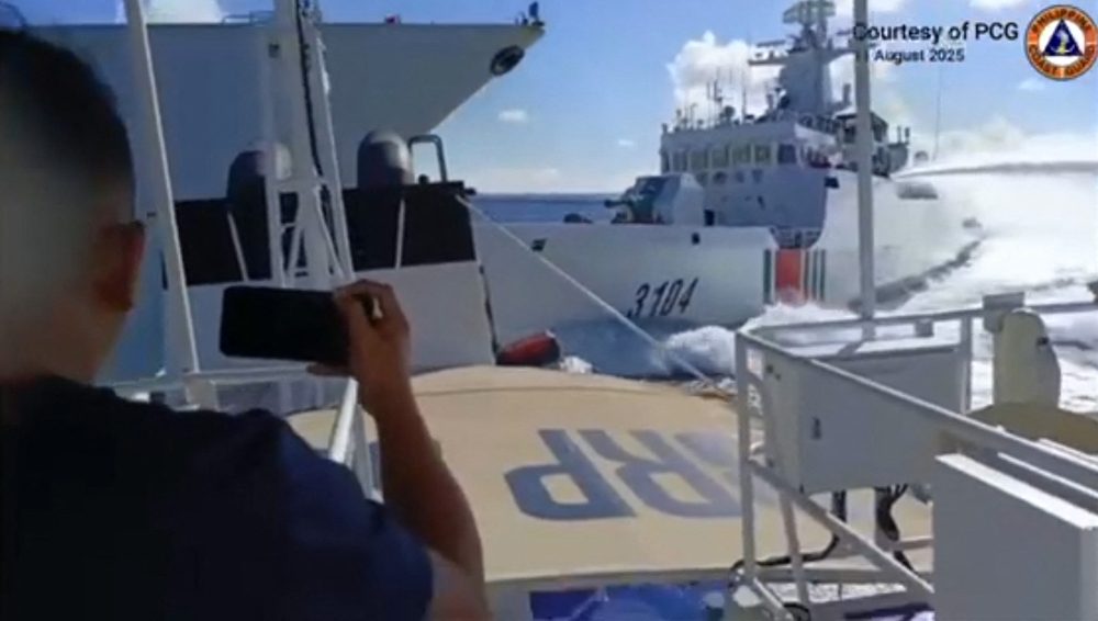 This handout video grab released and taken on August 11, 2025 by the Philippine Coast Guard shows an incident between a Chinese Navy vessel (left) and a Chinese Coast Guard ship (right) as seen from a Philippine fisheries boat near Scarborough Shoal in the disputed South China Sea. — AFP pic/Philippine Coast Guard Handout