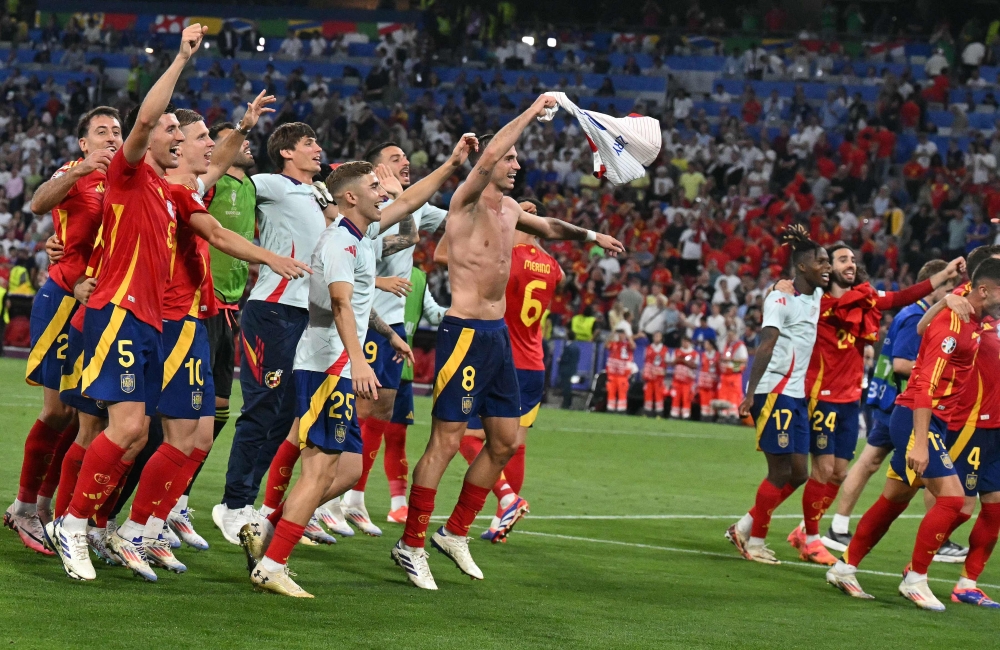 Spain’s players celebrate at the end of the Uefa Euro 2024 semi-final football match between Spain and France at the Munich Football Arena in Munich on July 9, 2024. — AFP pic