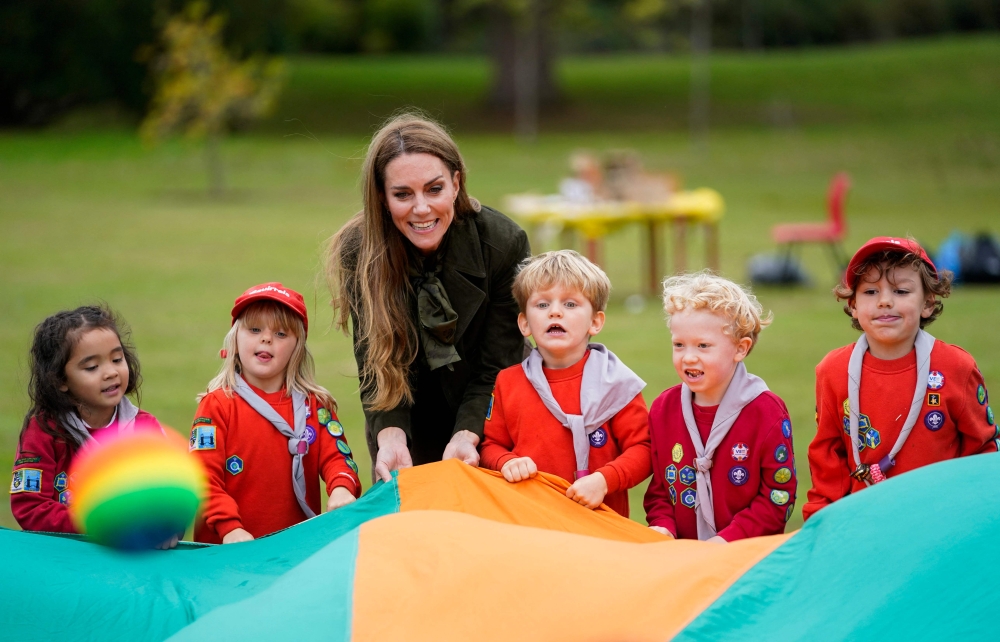 Catherine, Princess of Wales shakes a parachute filled with balls with a group of Squirrels from the Scout Association at Frogmore Cottage on the Windsor Estate, in Windsor, September 18, 2025, during the second State Visit of US President Donald Trump. — AFP pic