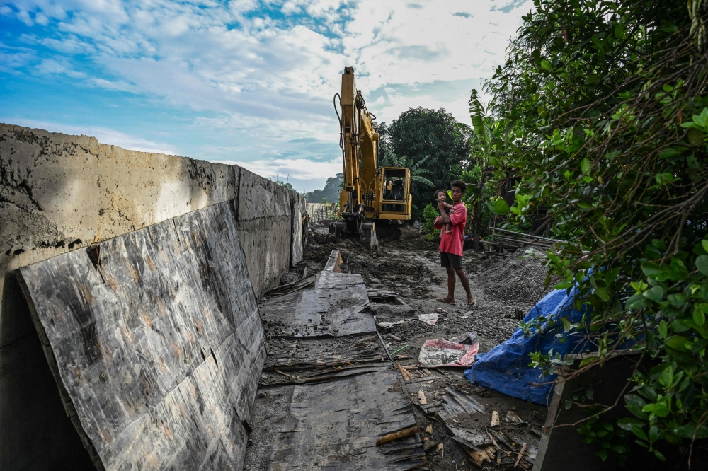 A man stands at the site of the unfinished dike in Plaridel, Bulacan, September 15, 2025. — AFP pic