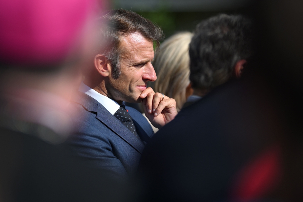 France's President Emmanuel Macron reacts during a visit to the Benedictine abbey of Pontlevoy, as part of the 42nd edition of the European Heritage Days, in Pontlevoy central France September 19, 2025. — Eliot Blondet/Pool/AFP pic