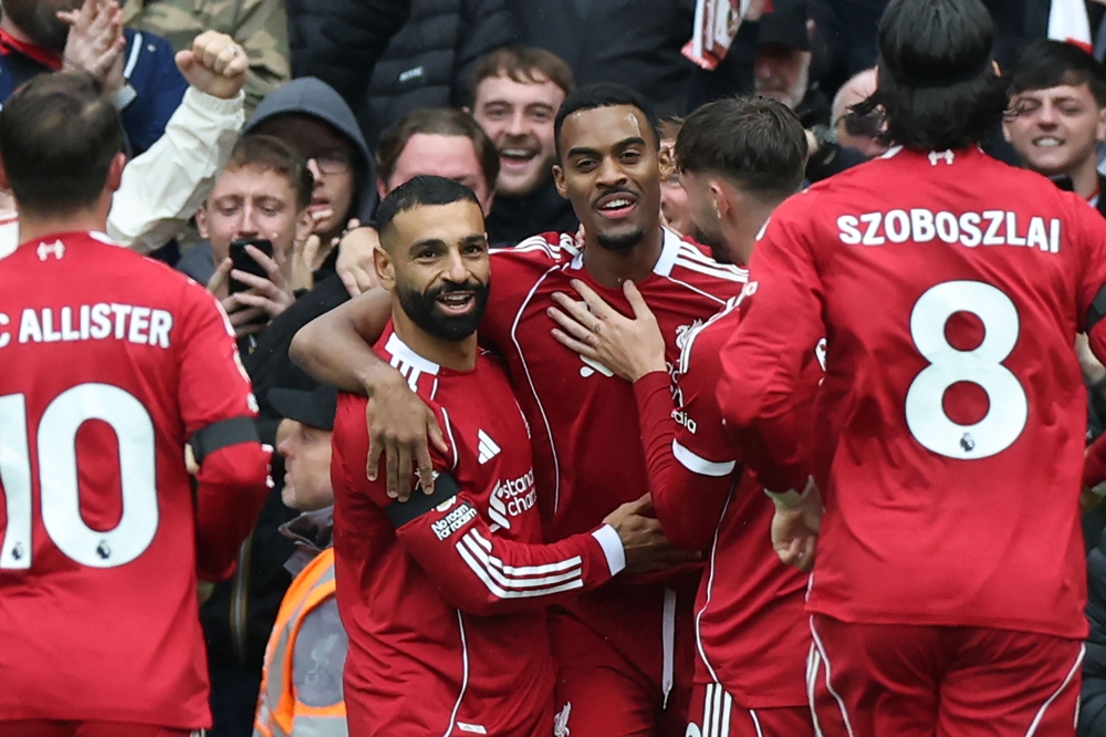 Liverpool’s Ryan Gravenberch celebrates with Mohamed Salah after scoring the opening goal of the Premier League match with Everton at Anfield in Liverpool September 20, 2025. — AFP pic