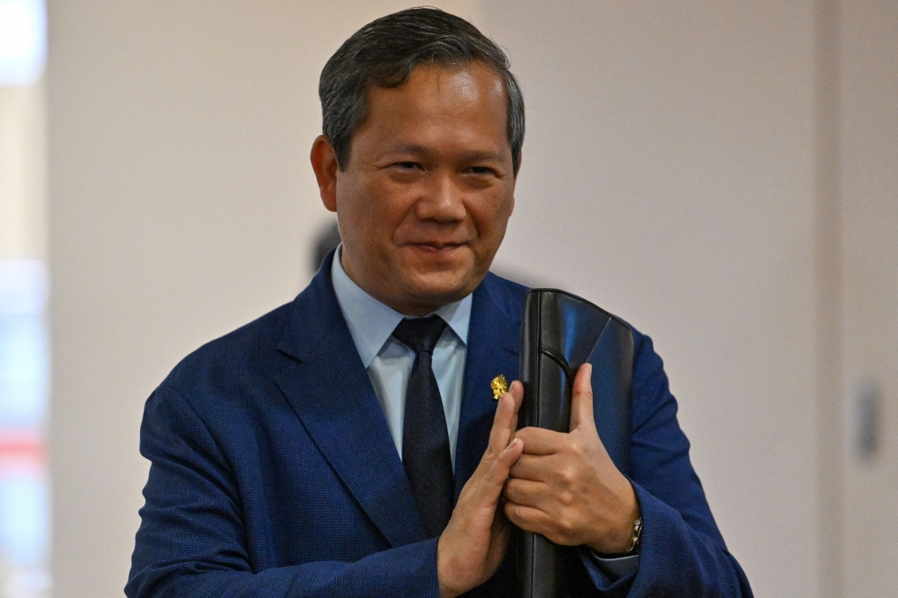 Cambodia’s Prime Minister Hun Manet greets people as he arrives for a meeting at the National Assembly building in Phnom Penh on August 25, 2025. — AFP pic