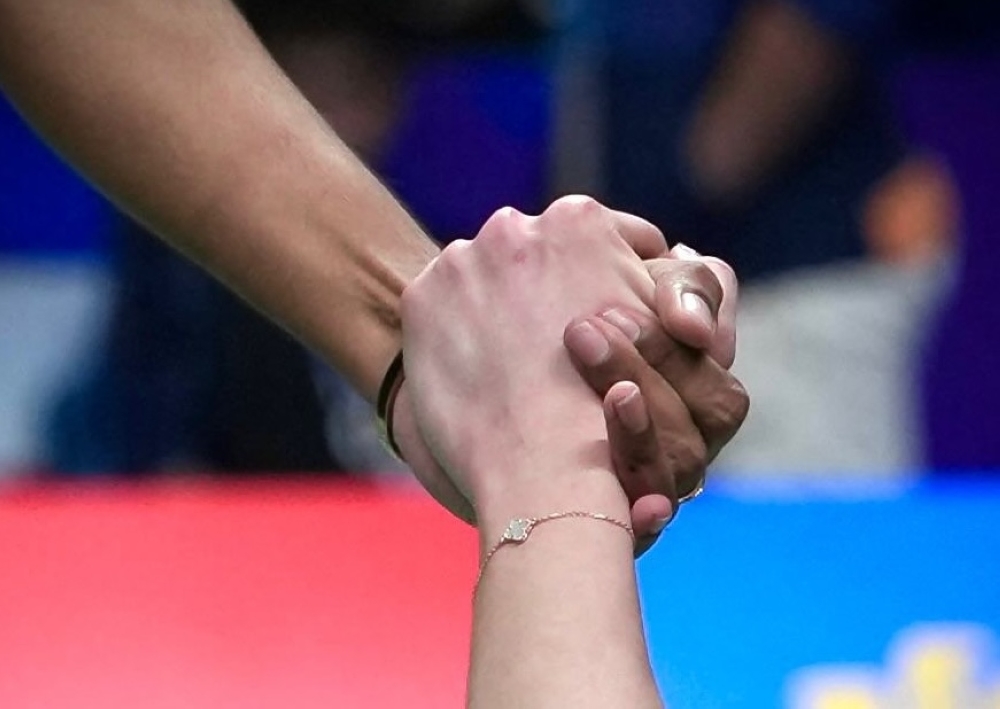 Pearly Tan posted this heartfelt moment of women’s doubles partner M Thinaah helping her up after a fall. — Picture via Facebook/Pearly Tan