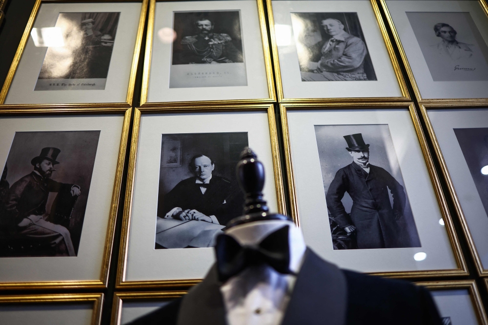 Portraits of historic clients on the wall inside Henry Poole & Co on Savile Row in London on August 12, 2025. — AFP pic 