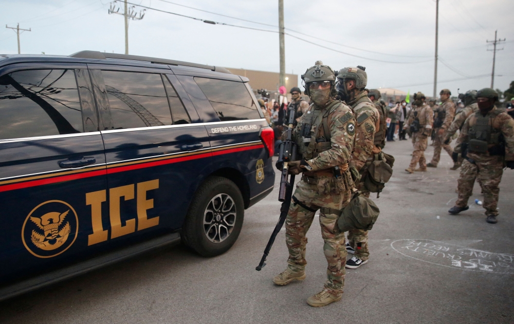 Immigration and Customs Enforcement (ICE) agents armed with less-lethal weapons gather outside an ICE processing center during a protest in Broadview, Illinois, on September 19, 2025. — AFP pic 