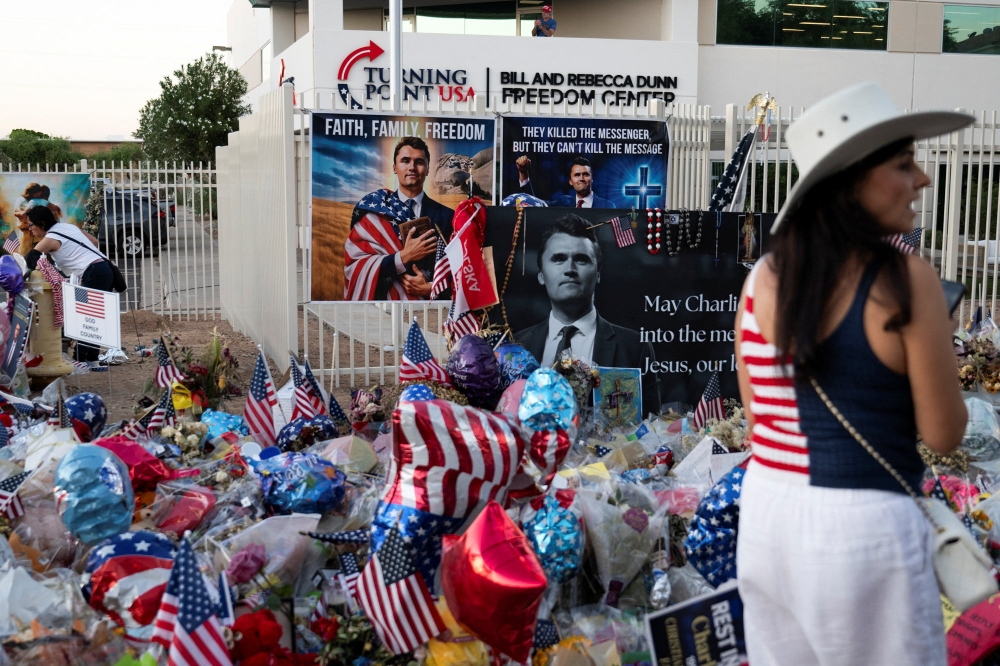 A supporter attends a vigil in memory of right-wing activist Charlie Kirk who was fatally shot during an event at Utah Valley University, outside the headquarters of Turning Point USA in Phoenix, Arizona September 19, 2025. — Reuters pic 