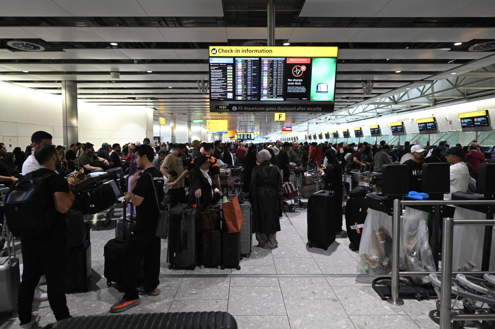 Travellers wait in terminal 4 at Heathrow Airport, west of London on September 20, 2025. — AFP pic 