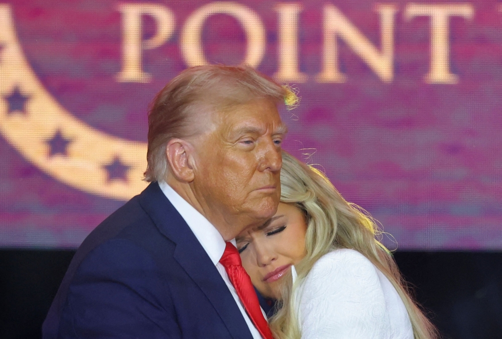 US President Donald Trump embraces Erika Kirk, during a memorial service for her husband, slain conservative commentator Charlie Kirk, at State Farm Stadium in Arizona September 21, 2025. — Reuters pic  