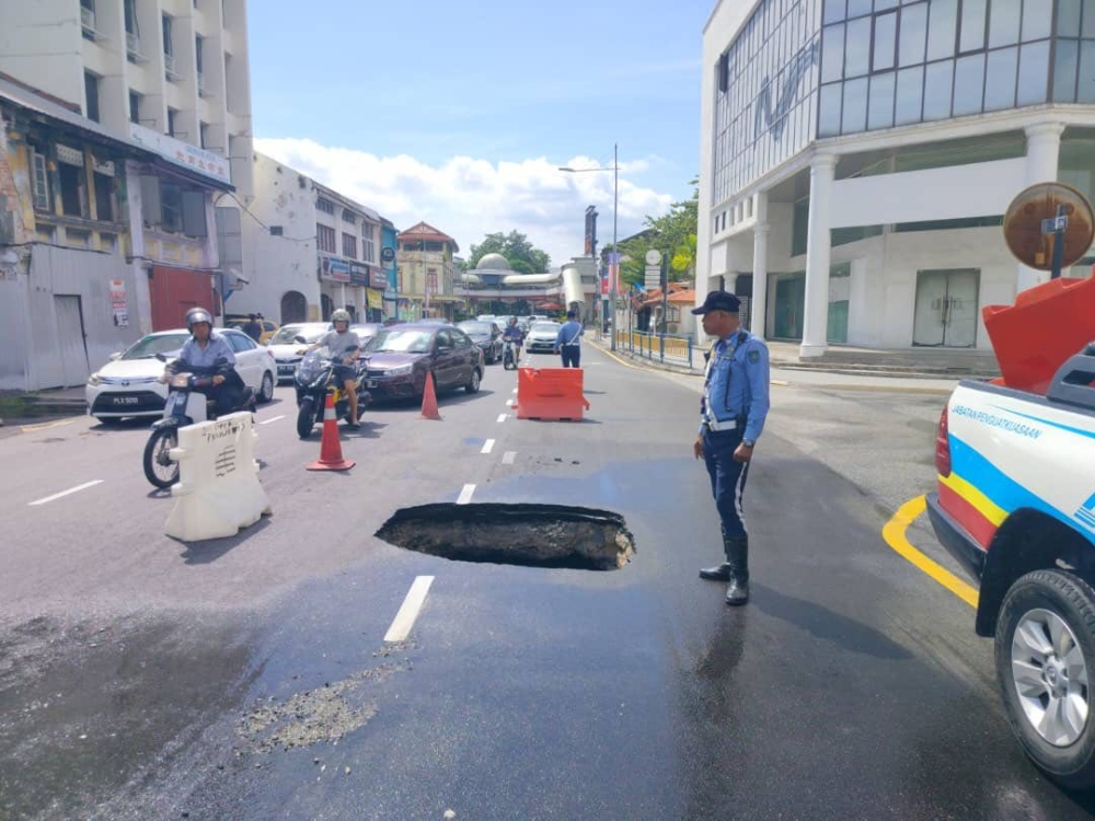 The sinkhole was caused by a burst high pressure IWK pipe that was the main sewage pipeline in the area. — Picture via Facebook/MBPP