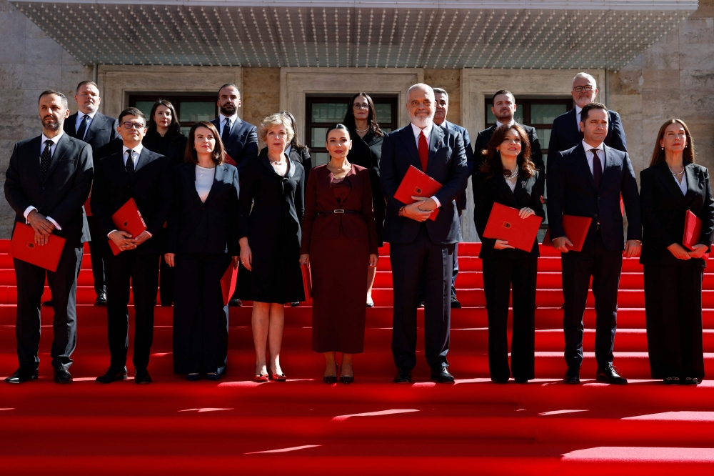 Albania’s Prime Minister Edi Rama (4th right), flanked by Albania’s Deputy Prime Minister or Instrastructure and Energy (centre) and his newly sworn-in cabinet pose for a family photograph in front of the headquarters of the Government of Albania in Tirana, on September 19, 2025. — AFP pic 