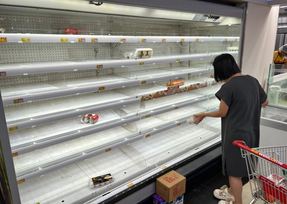 A woman buys eggs at a supermarket as Super Typhoon Ragasa approaches to Hong Kong September 23, 2025. — AFP pic