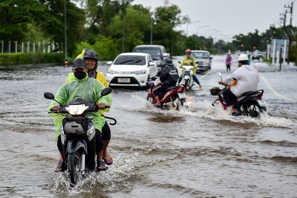 Motorists make their way through flood waters following heavy rain in Thailand's southern province of Narathiwat on November 28, 2024. Four people were killed in flooding in central Thailand, the nation’s disaster agency said today. — AFP pic 