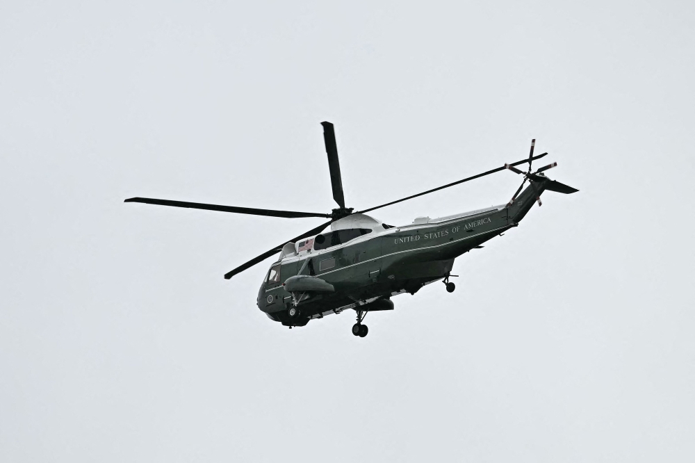 One of three helicopter's in US President Donald Trump entourage flies over Windsor Castle, in Windsor September 17, 2025. US authorities charged a man who shone a laser pointer at the presidential helicopter as it departed the White House with President Trump aboard, according to a court filing yesterday. — AFP pic 