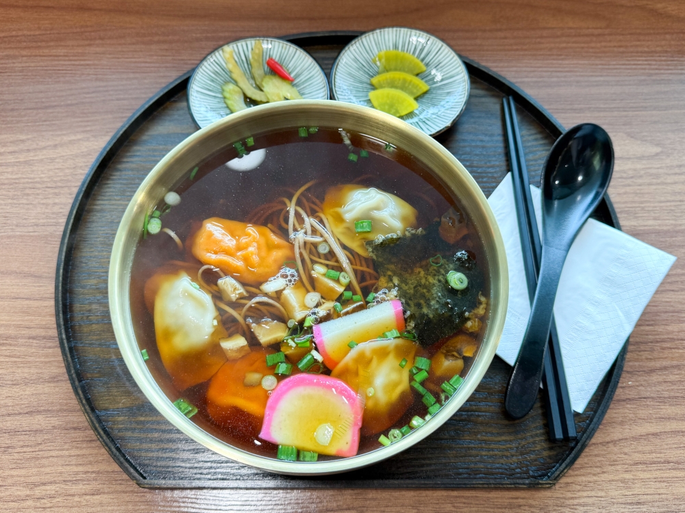 Mandu Soba is slowly savoured with the silky dumplings and a mushroom broth mixed with perilla powder. — Picture by Lee Khang Yi