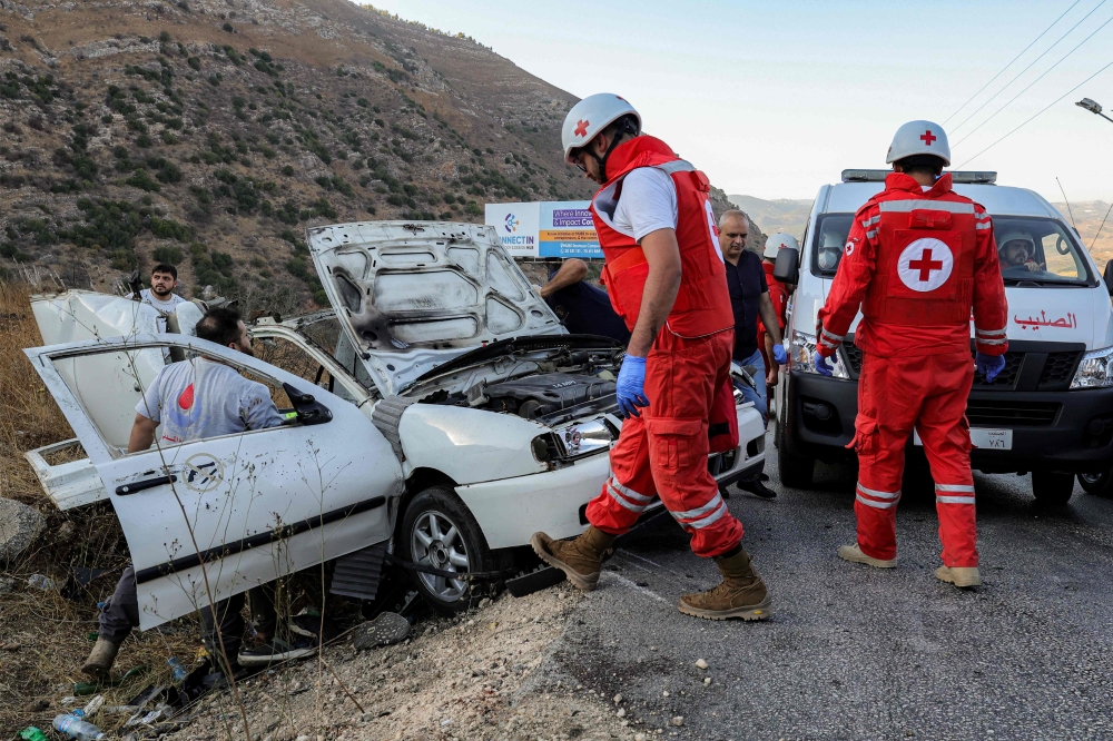 First responders and security forces’ members gather at the site of an Israeli strike on a vehicle on the Khardali road in south Lebanon’s Marjayoun area on September 20, 2025. — AFP pic 