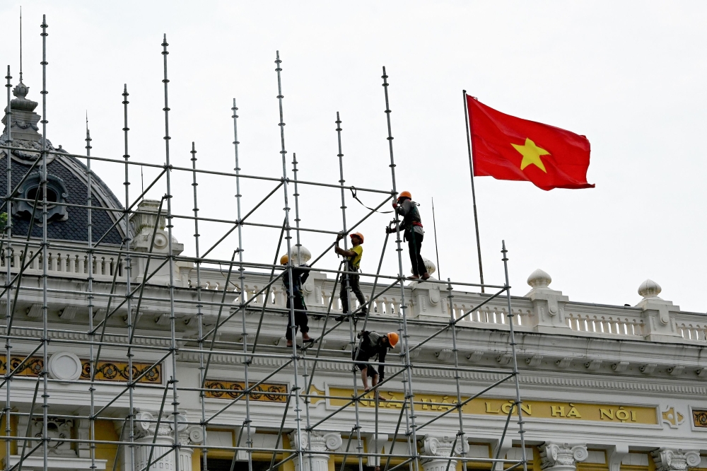 The Vietnamese flag is seen as workers install stage scaffolding in front of the Hanoi Opera House in Hanoi September 22, 2025. Vietnam’s prime minister said Hanoi was pursuing new trade deals this year to mitigate the impact of tariffs imposed on its goods by the US. — AFP pic