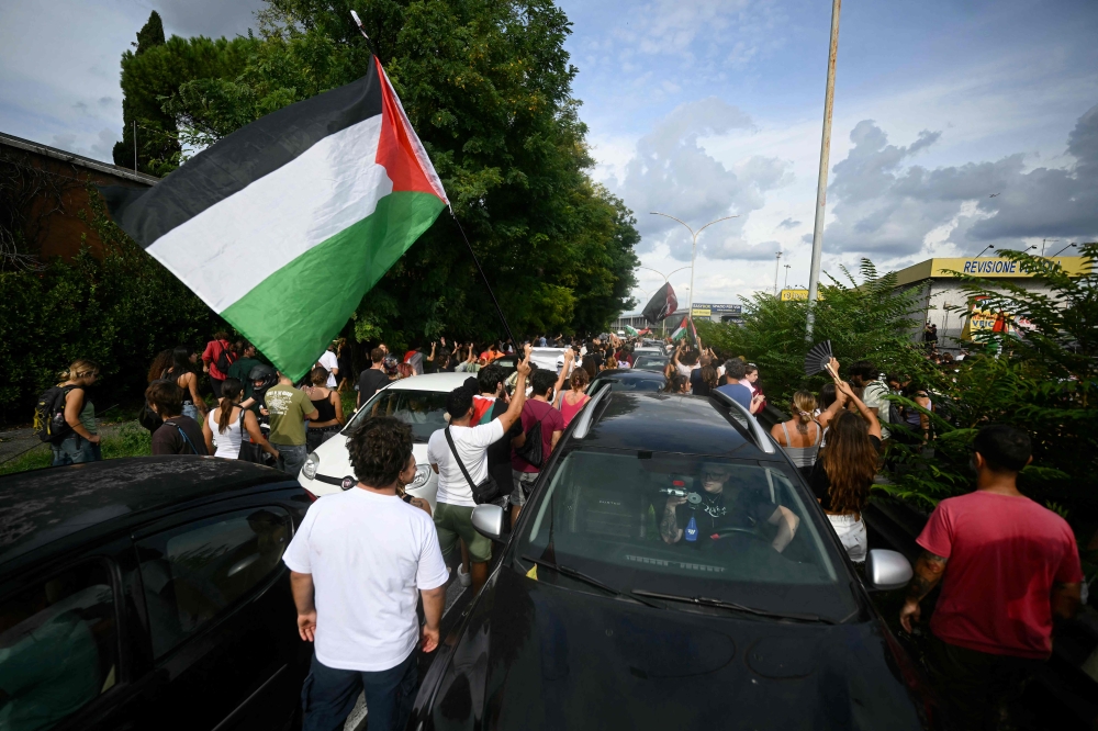 Protesters block the traffic during a march part of the nationwide strike 'Let's Block Everything' in solidarity with Palestinians in Gaza and calling for a halt to arms shipments to Israel, in Rome on September 22. — AFP pic