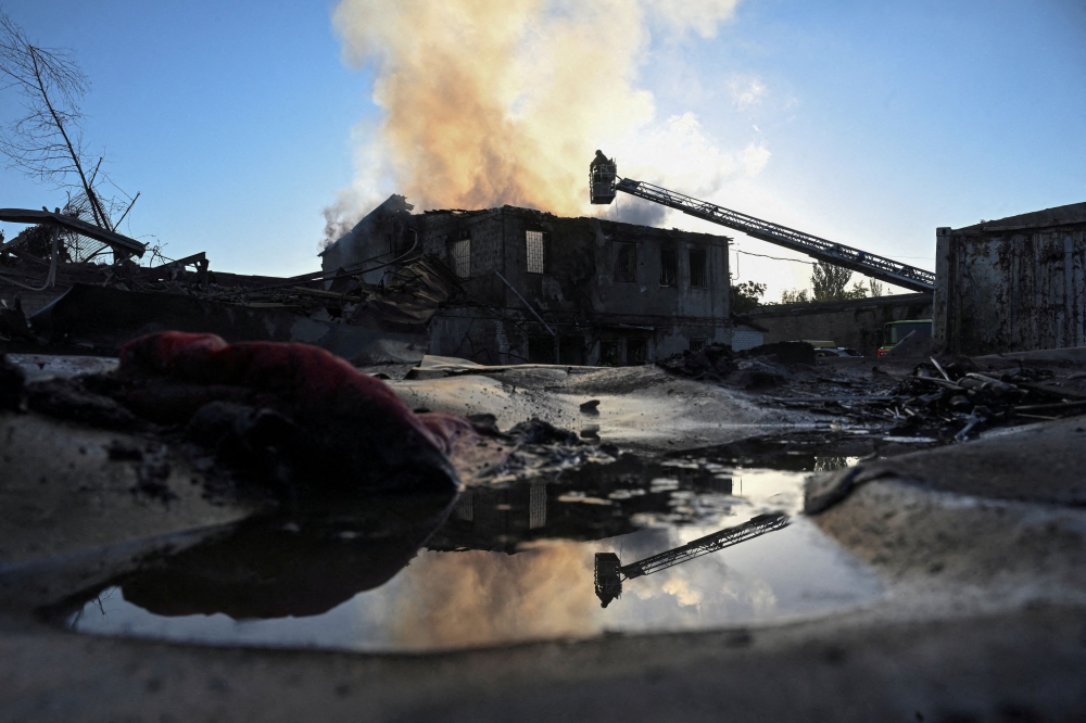 A firefighter works at the site of a private enterprise damaged during a Russian air strike, amid Russia’s attack on Ukraine, in Zaporizhzhia, Ukraine September 22, 2025. — Reuters pic 