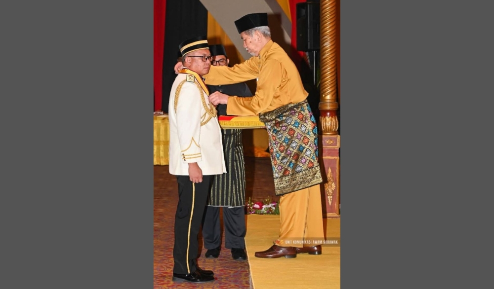 Hasbilah (left) receives the PBK honours from Wan Junaidi. — Sarawak Public Communications Unit pic