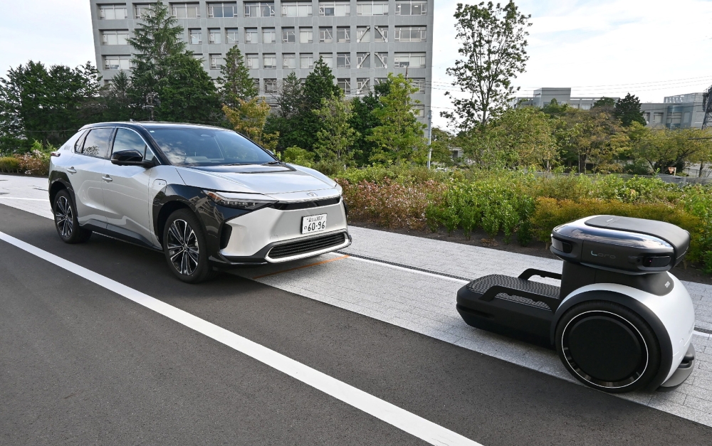 An autonomous robot (right) guides and transports shared cars inside Toyota Motor Corporation's ‘Woven City’ in the city of Susono, Shizuoka Prefecture September 25, 2025. — AFP pic