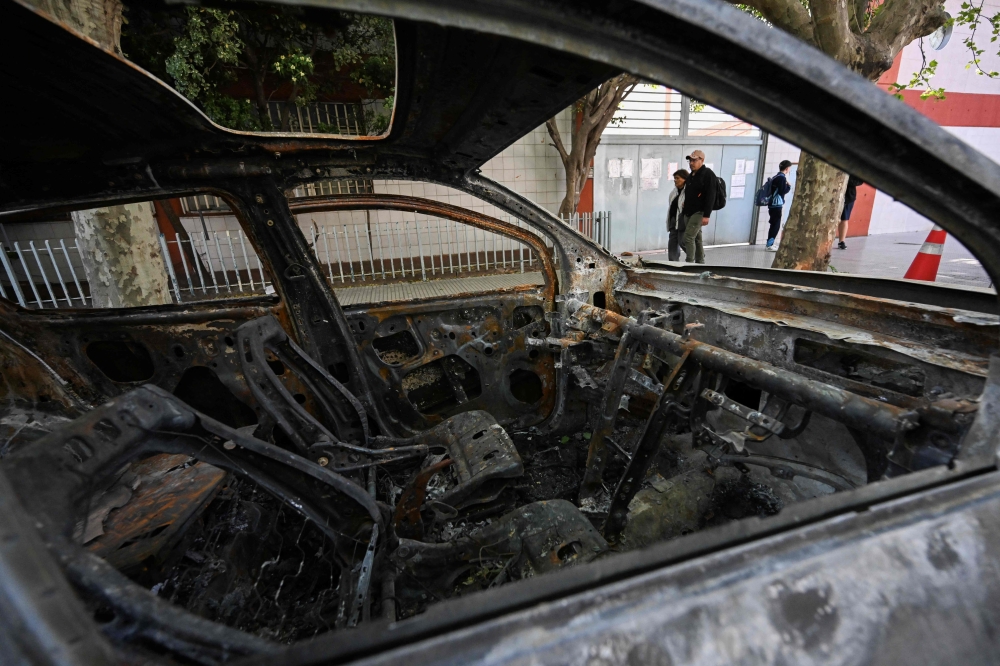The burned car that allegedly transported Brenda del Castillo, Morena Verdi and Lara Gutierrez is seen in front of a police station in La Tablada, on the outskirts of Buenos Aires September 26, 2025. — AFP pic