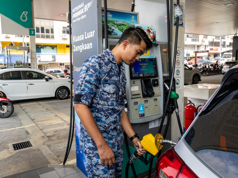 Captain Zarith Ruslan from INSMAT (Material Management Training Institute) pumps petrol under the new Budi95 subsidy at a Petronas station in Kuala Lumpur September 27, 2025. — Picture by Firdaus Latif