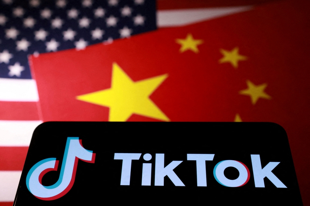 President Donald Trump insists he has found a solution to keep TikTok alive in the United States through a group of investors who will buy the short-video app from its Chinese owners in accordance with US law. — Reuters pic