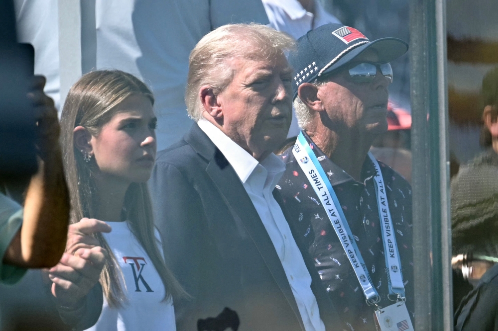 US President Donald Trump with his granddaughter Kai Madison Trump, 18, at the 45th Ryder Cup, Bethpage Black Golf Course, Farmingdale, New York, US yesterday. — Reuters pic