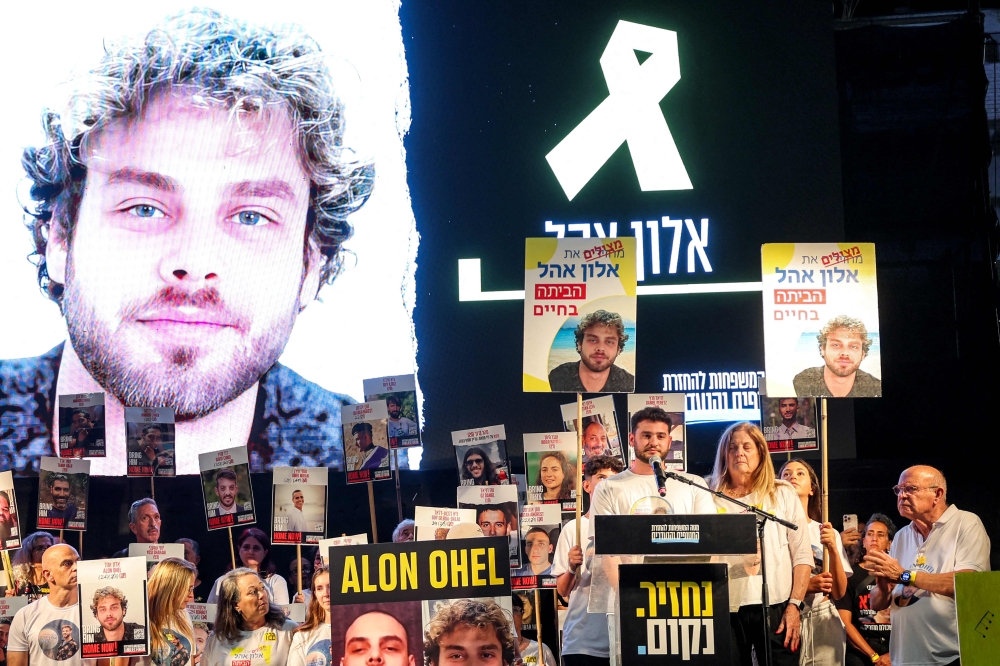 Ronen Ohel, brother of Israeli hostage Alon Ohel, speaks on the podium during an anti-government protest organised by the families of the other Israeli hostages taken captive in the Gaza Strip since the October 2023. — AFP pic 