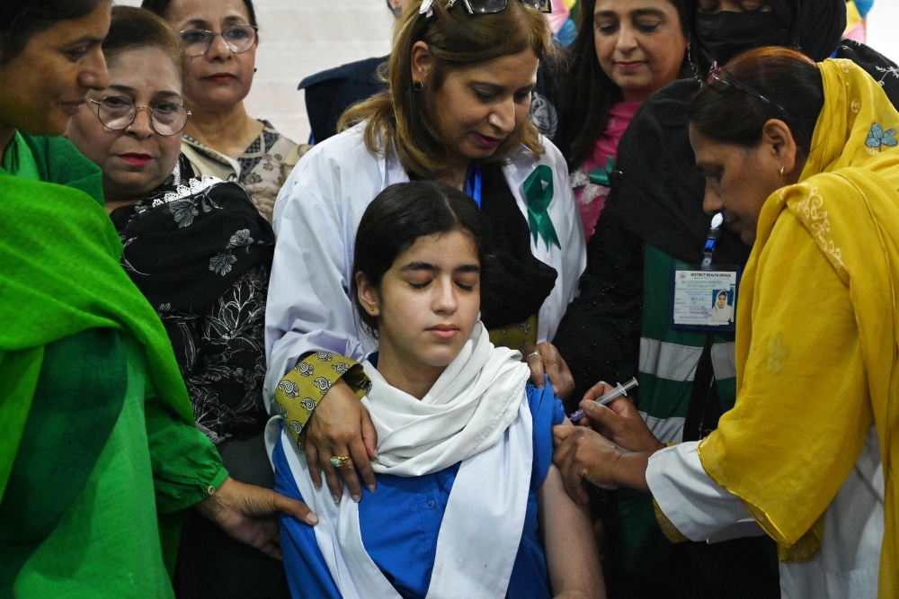 A health worker administers an HPV vaccine to a schoolgirl in Islamabad on September 24, 2025. The nationwide campaign was marred by misinformation and school closures. — AFP pic