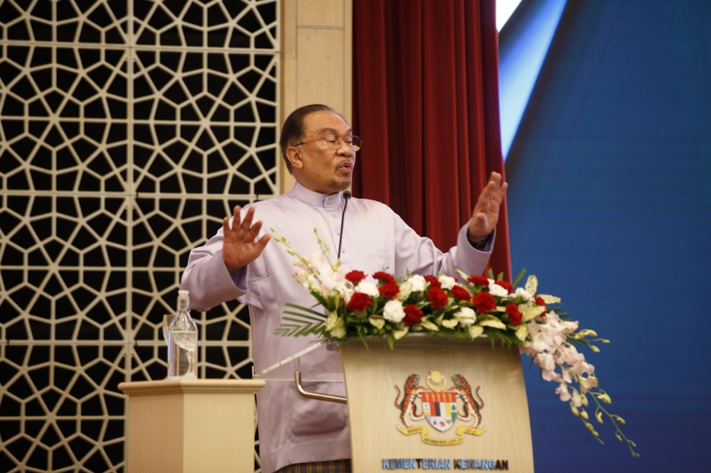 Prime Minister Datuk Seri Anwar Ibrahim delivers his speech at the Ministry of Finance staff gathering in Putrajaya on September 24, 2025. — Picture by Raymond Manuel