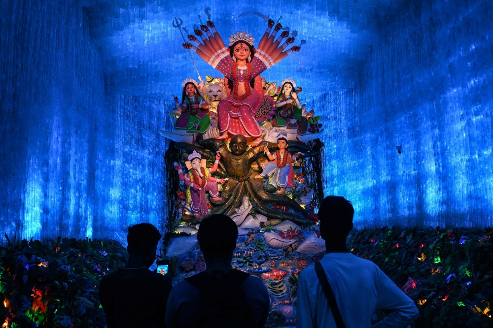 Devotees visit a 'pandal' (temporary structure for worship), decorated with used plastic bottles, of the Hindu goddess Durga in Kolkata on September 24, 2025, ahead of the Durga Puja festival. — AFP pic 