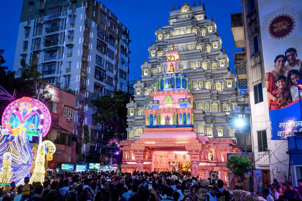 Devotees throng at the entrance during a visit to the 'Pandal' (temporary structure for worship) with an idol of the Hindu goddess Durga on the eve of the 'Durga Puja' festival in Kolkata on September 27, 2025. — AFP pic 
