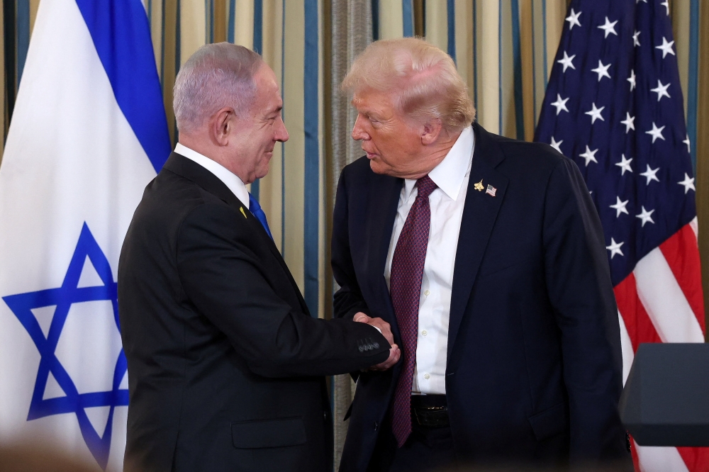 US President Donald Trump and Israeli Prime Minister Benjamin Netanyahu shake hands at a joint press conference at the White House in Washington, DC, on September 29, 2025. — Reuters pic