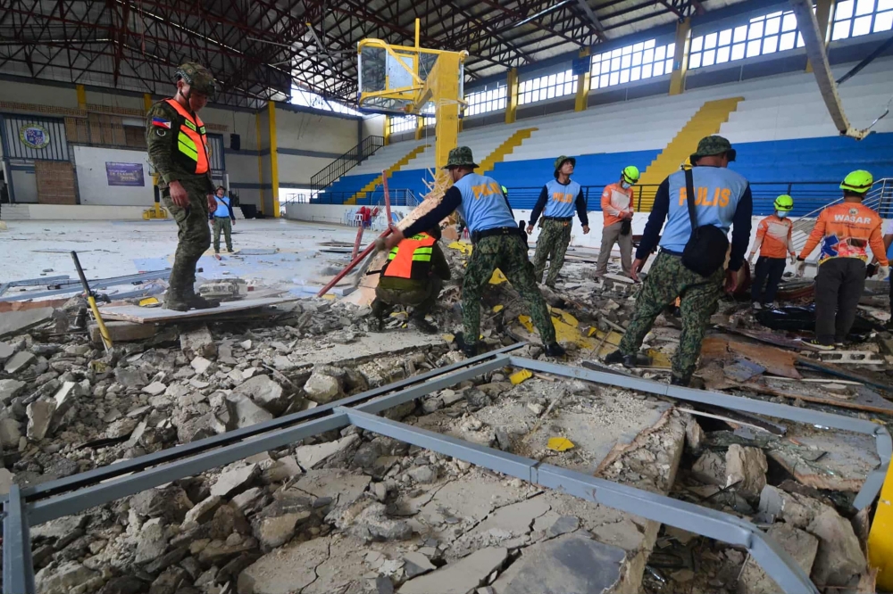 The police and rescuers inspect the damage at an indoor arena in San Remigio town, Cebu province, central Philippines, on October 1, 2025, after a powerful 6.9-magnitude earthquake jolted the central Philippines, collapsing buildings and killing at least 26 people. — AFP pic
