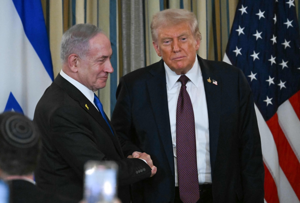 US President Donald Trump and Israeli Prime Minister Benjamin Netanyahu shake hands at the conclusion of a joint press conference in the State Dining Room of the White House in Washington, DC on September 29, 2025. Israeli Prime Minister Benjamin Netanyahu on September 29 said he supported US President Donald Trump’s 20-point plan to end the war in Gaza. — AFP pic 