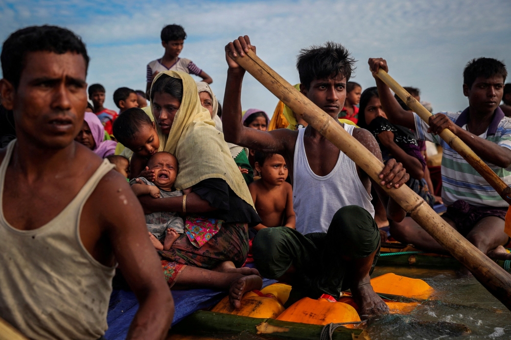 This file picture shows Rohingya refugees crossing the Naf River with an improvised raft to reach to Bangladesh in Teknaf, Bangladesh, November 12, 2017. — Reuters