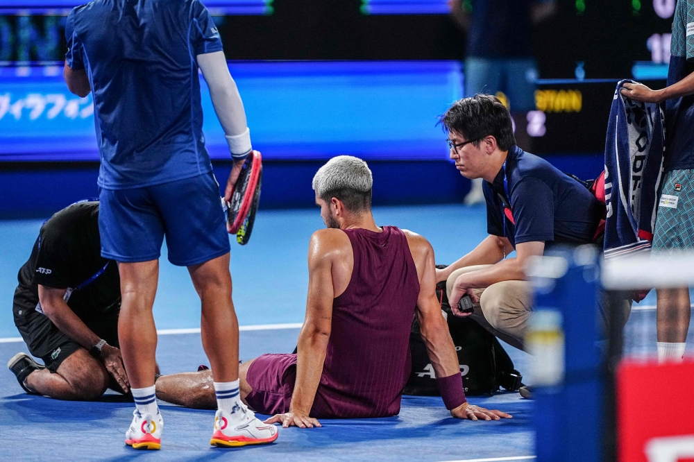 Carlos Alcaraz get medical attention during a match at the ATP Japan Open in Tokyo on September 25. — AFP pic