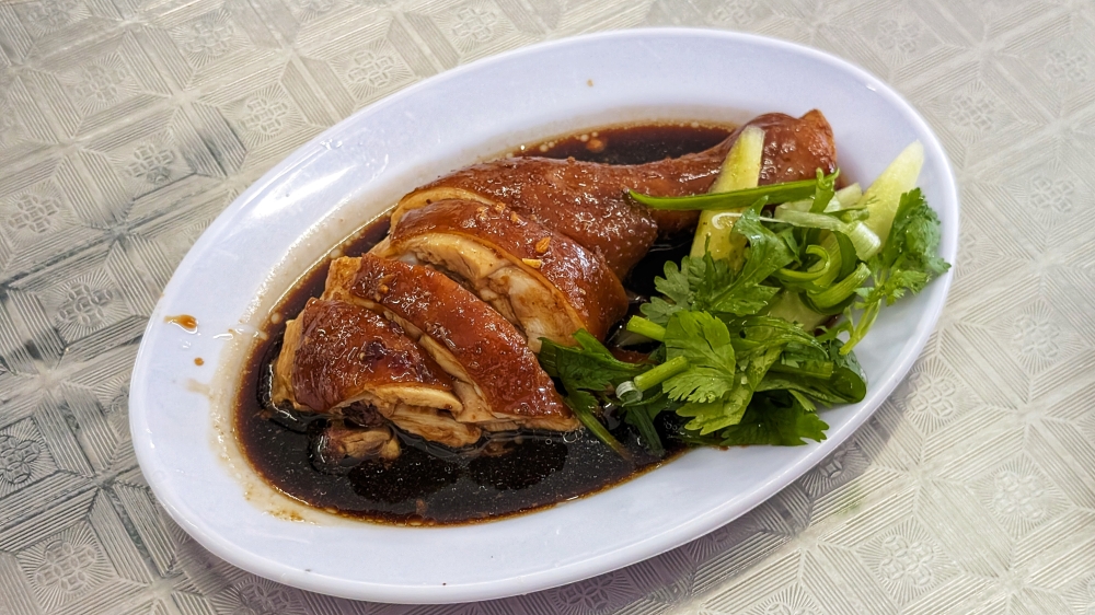 The braised chicken is actually soy sauce chicken, and it is the unsung hero here. — Picture by Ethan Lau