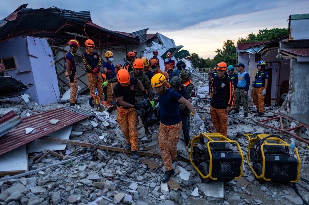 Rescuers carry a victim's body recovered from a damaged pension house in the aftermath of a magnitude 6.9 quake in Bogo, Cebu, Philippines, October 1, 2025. — Reuters pic