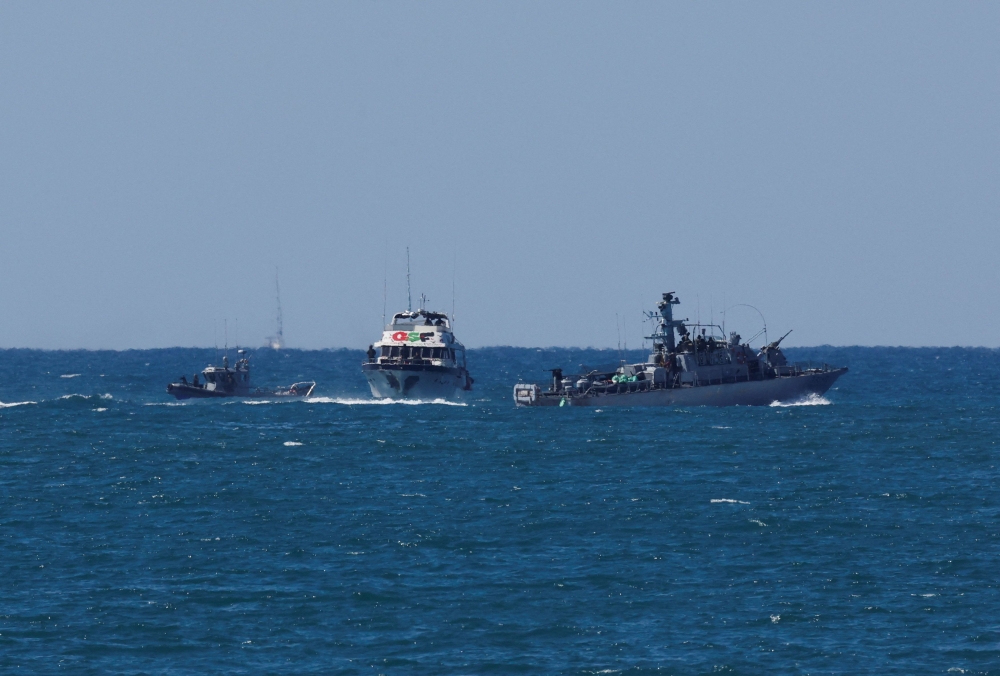 Israeli navy vessels escort a vessel from the Global Sumud Flotilla to Ashdod Port. — Reuters pic